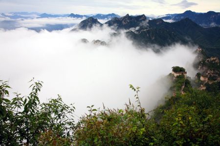 Photo taken on Sept. 6, 2009 shows the spectacular scene of vaporing and rosy cloud sea weltering over the mountain peaks, a rare scenery after the early Autumn rainfall, in the Xizha Village, in the suburb of Huairou District, Beijing. (Xinhua/Bu Xiangdong)